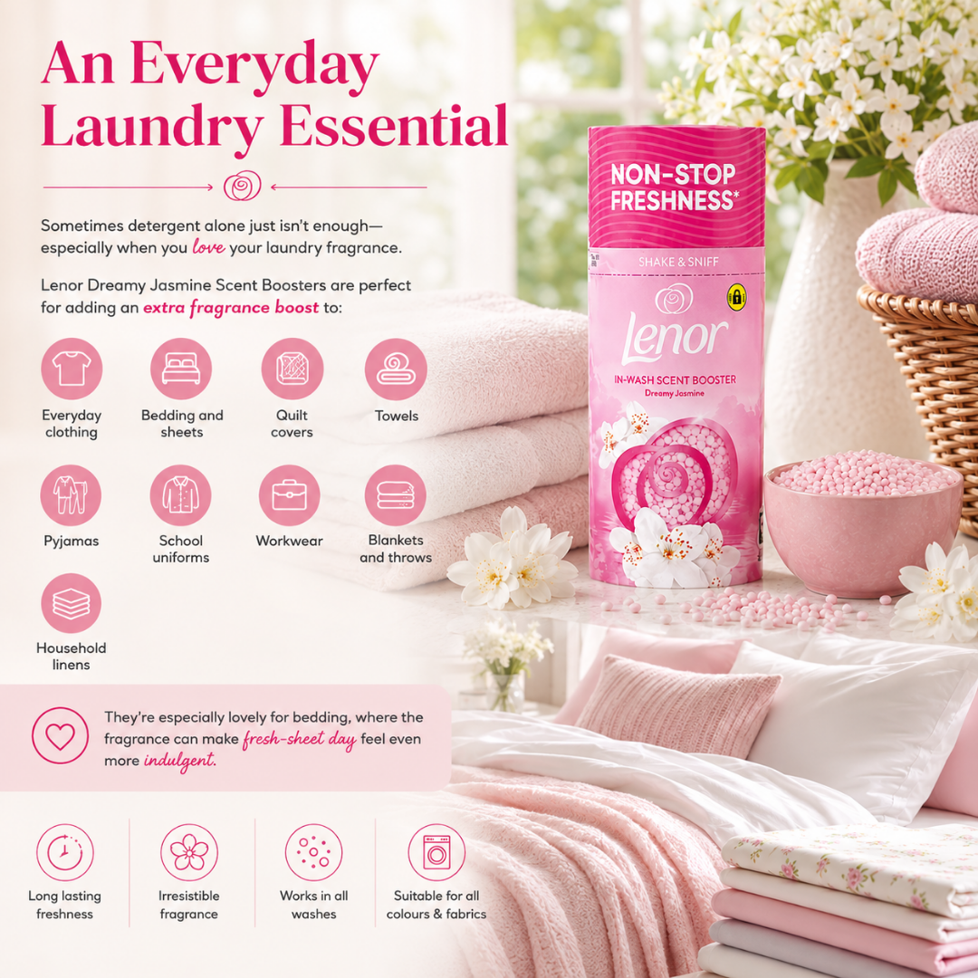 Lenor Dreamy Jasmine Scent Boosters bottle in pink, displayed on a styled background of folded pink and white laundry, bath towels, and flowers. The image includes descriptive text and icons detailing the product's use for various laundry items.