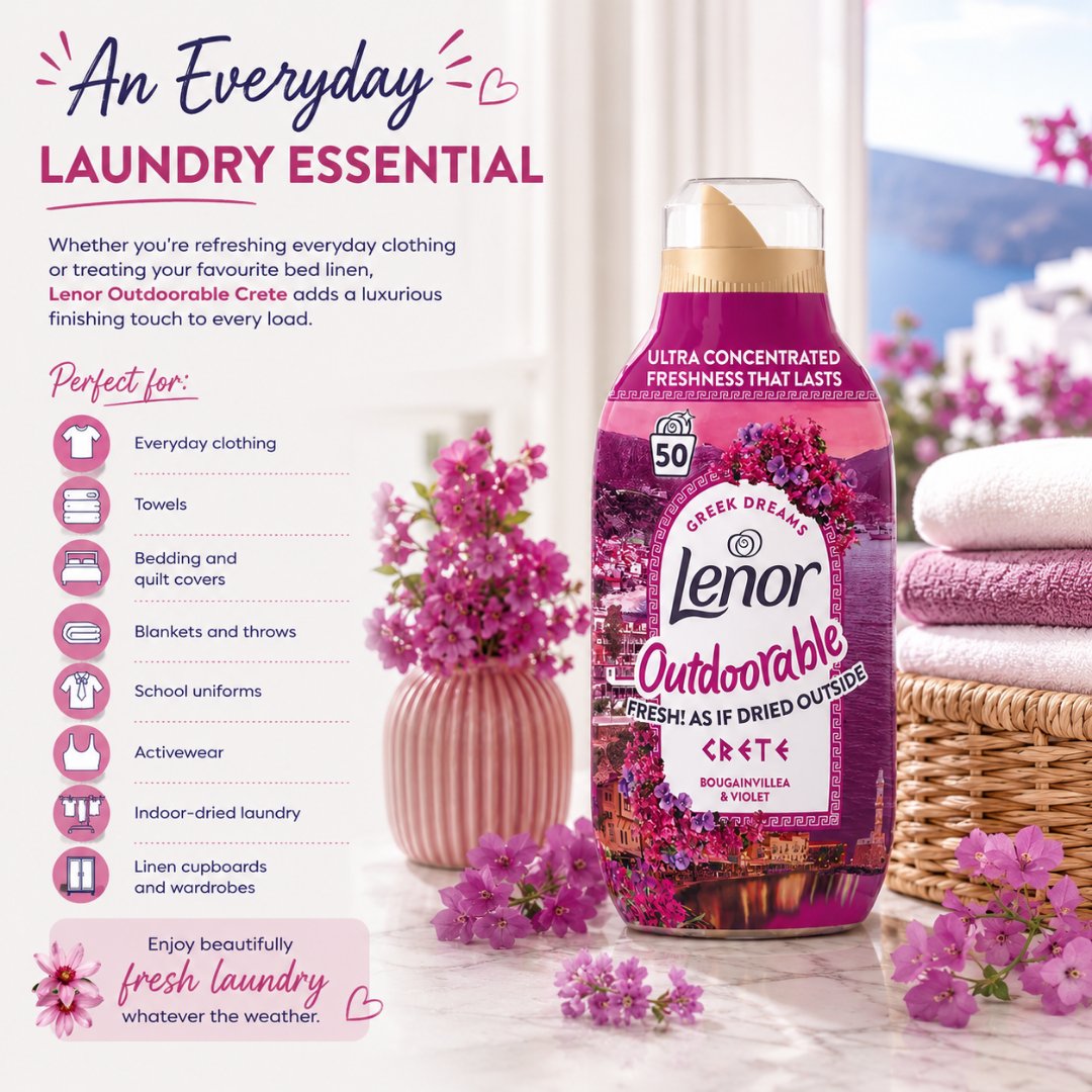 A bottle of Lenor Outdoorable Crete+ laundry detergent stands on a marble surface beside folded towels, flowers, and a basket, with marketing text on the left. The product bottle is pink and purple with a beige cap.
