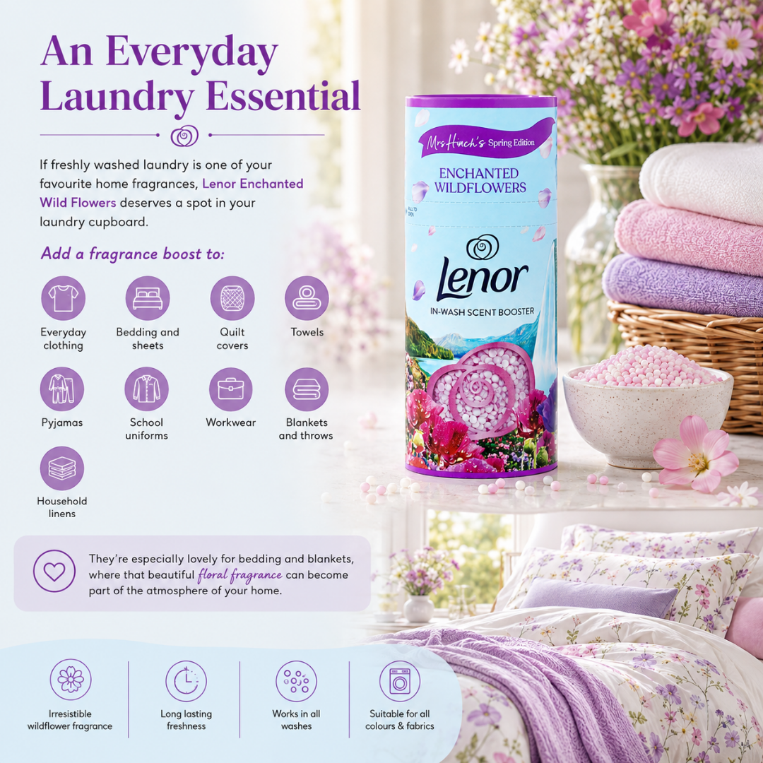 Lenor Enchanted Wildflowers laundry fragrance booster in a purple and blue cylindrical tin, displayed in a beautifully styled bedroom setting with lavender bedding, a stack of folded towels, and floral decor. The image includes promotional text detailing the scent and benefits of the fragrance booster.