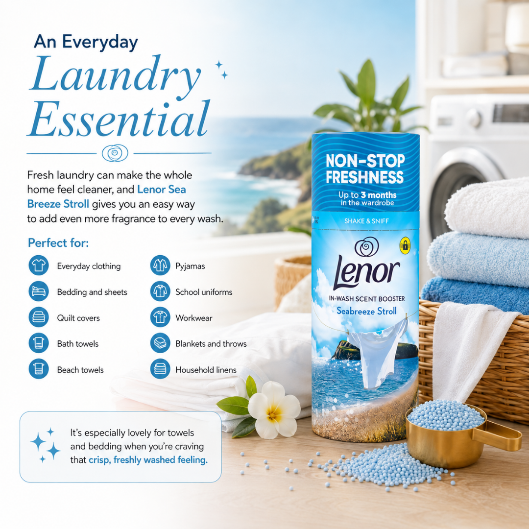 Lenor Seabreeze Stroll Non-Stop Freshness laundry scent booster in a blue and white bottle, styled on a beach-themed background with folded towels, a basket, and scattered blue beads, accompanied by descriptive text and icons.